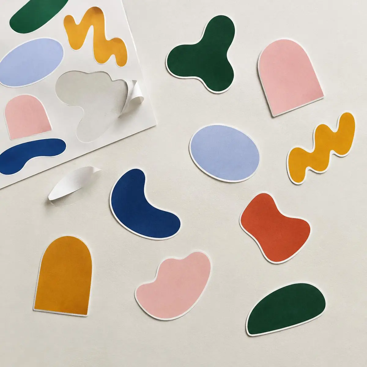 Die-cut stickers in abstract shapes on a backing sheet